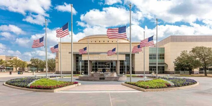 American flags at half-staff around a library entrance