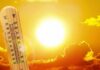 thermometer in front of a blazing sun and orange sky
