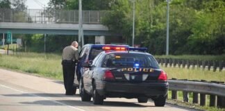Police officer conducting a traffic stop on a highway