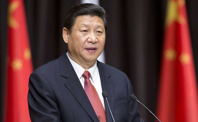 Xi Jinping speaking at a podium with microphones