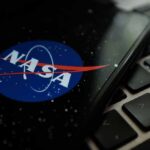 Orbit-Only Shock Upends Artemis Hype NASA logo on smartphone resting on a laptop keyboard