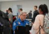 tsa officer checks a traveler's documents at airport security