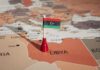 Libyan flag pin on a map of Libya