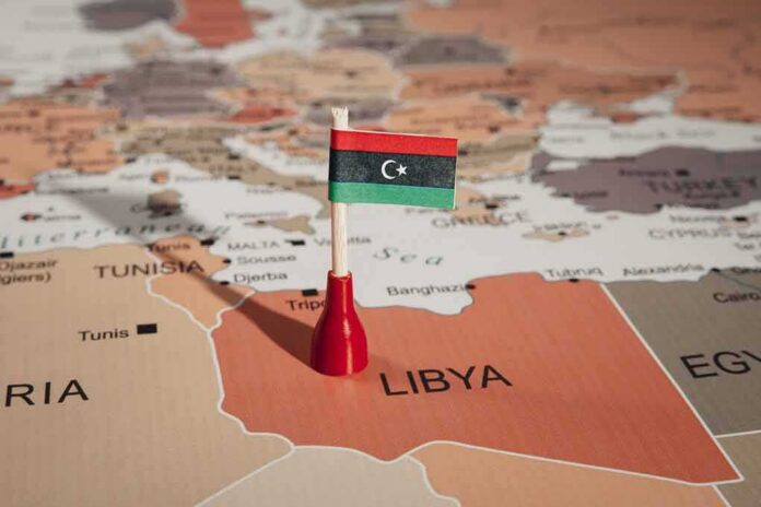 Libyan flag pin on a map of Libya