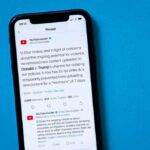 Trump’s Meme Storm Sparks Panic smartphone displaying a social media thread on a blue background