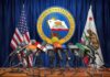 Labor Dept. Probe Hits California Press microphones at a podium before California governor seal
