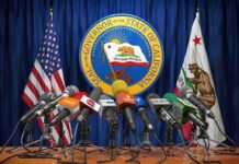 Labor Dept. Probe Hits California Press microphones at a podium before California governor seal