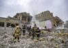 Firefighters search rubble of a partially collapsed building