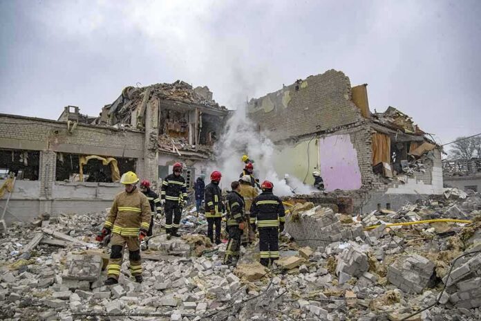Firefighters search rubble of a partially collapsed building