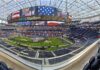 Football stadium interior with large video board and empty seating