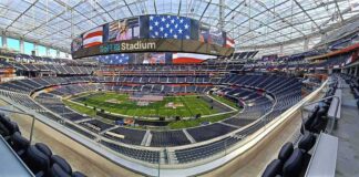 Football stadium interior with large video board and empty seating
