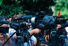 Replay Twist Flips Game — Fans Fume TV news cameras crowding together at an outdoor event