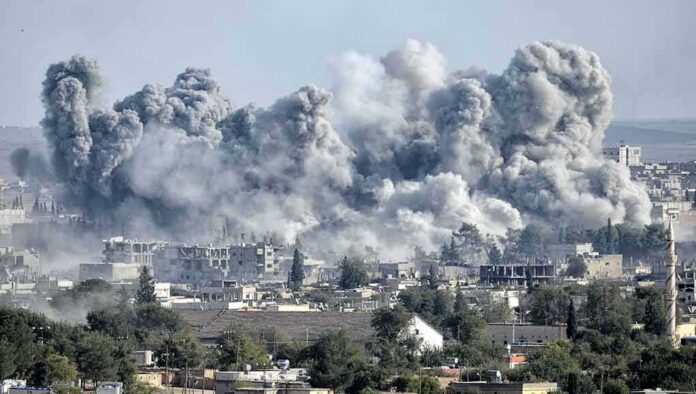 Massive smoke plumes rise over a city after explosions