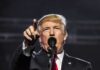 Nicki-Minaj – Trump Bond Deepens man speaking at a microphone and pointing forward