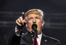 Nicki-Minaj – Trump Bond Deepens man speaking at a microphone and pointing forward