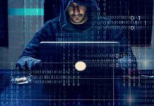 Global Scam Empire Busted – 3.7M Accounts Gone Person in hoodie using a laptop with binary code overlay