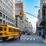 School Bus Horror In Florida City street with yellow school bus passing under traffic light