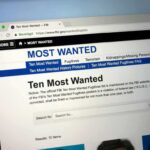 Vote-Buying Bombshell Triggers DOJ Heat Computer screen showing an FBI Most Wanted webpage