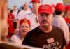 Darren Balsley in a red cap at a crowded outdoor event