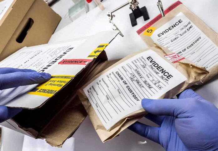 shutterstock_1400793416-1 Gloved hands handling labeled evidence bags and boxes