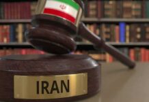 Judge's gavel with Iran label in law library