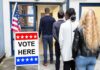 Voters standing in line at a polling place entrance