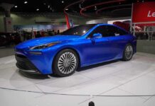 Blue sedan on display at an auto show