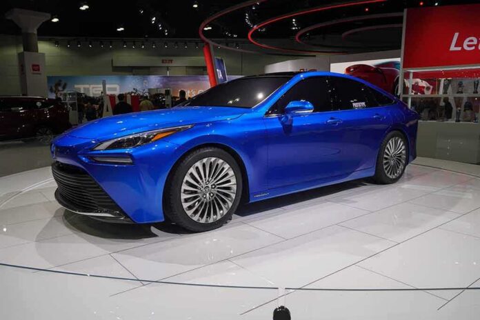 Blue sedan on display at an auto show