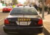 Aggressive Raccoon Triggers Rabies Alarm Sheriff patrol car parked on city street