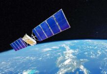 Satellite with blue solar panels orbiting Earth
