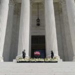 Ex-Speaker Dies – Legacy Upended Flag-draped casket on courthouse steps between towering columns