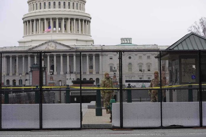 shutterstock_1889753536 US Capitol behind security fence with guards