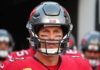 football player in helmet and red jersey looking forward