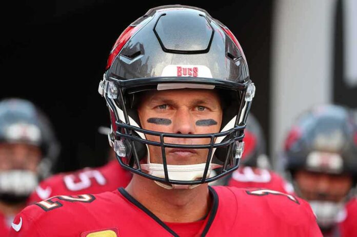 shutterstock_2091006637 football player in helmet and red jersey looking forward