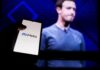 Mark Zuckerberg on screen with a hand holding a phone showing the Meta logo