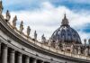St. Peter's Basilica dome with statues along colonnade