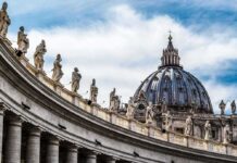 Rome On Edge: Pope Heads To OR St. Peter's Basilica dome with statues along colonnade