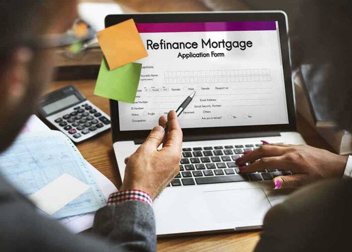 shutterstock_481694410 Laptop displaying refinance mortgage application form