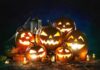Jack-o'-lanterns glowing with candles at night