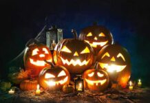 Jack-o'-lanterns glowing with candles at night