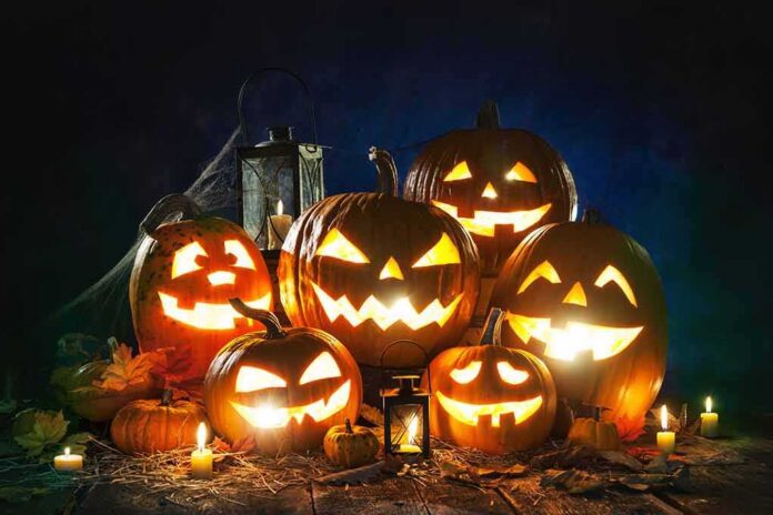 Jack-o'-lanterns glowing with candles at night